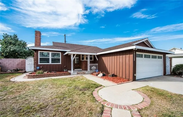 a view of a backyard with table and chairs and a large tree