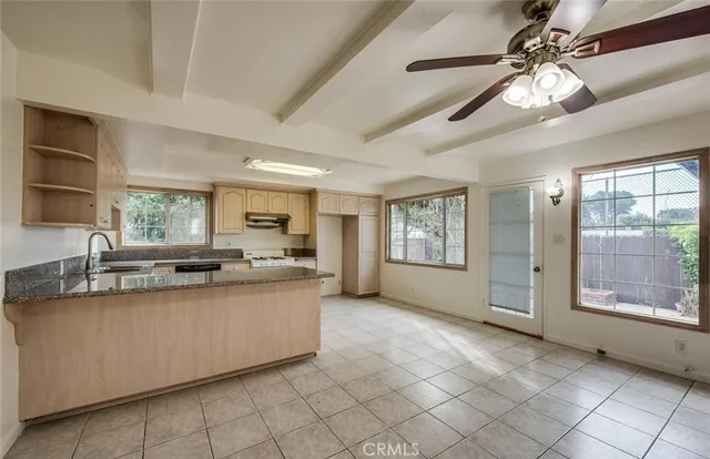 a kitchen with stainless steel appliances a sink stove and cabinets