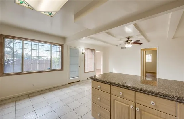 a bathroom with a granite countertop sink mirror and cabinets