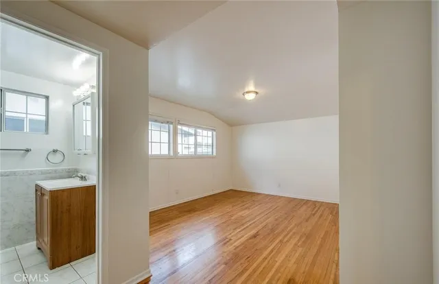 a view of a room with wooden floor and windows