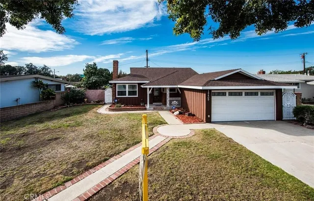 a front view of a house with yard porch and a sitting area