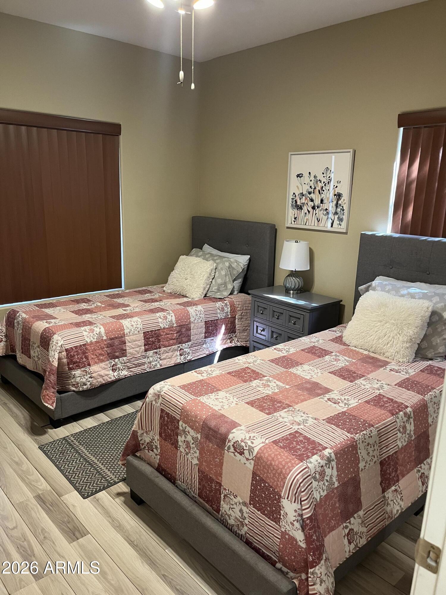 10030 West Indian School Road, Unit 133 Phoenix, AZ 85037 - Photo 13 of 17 a bedroom with double bed and a night stand