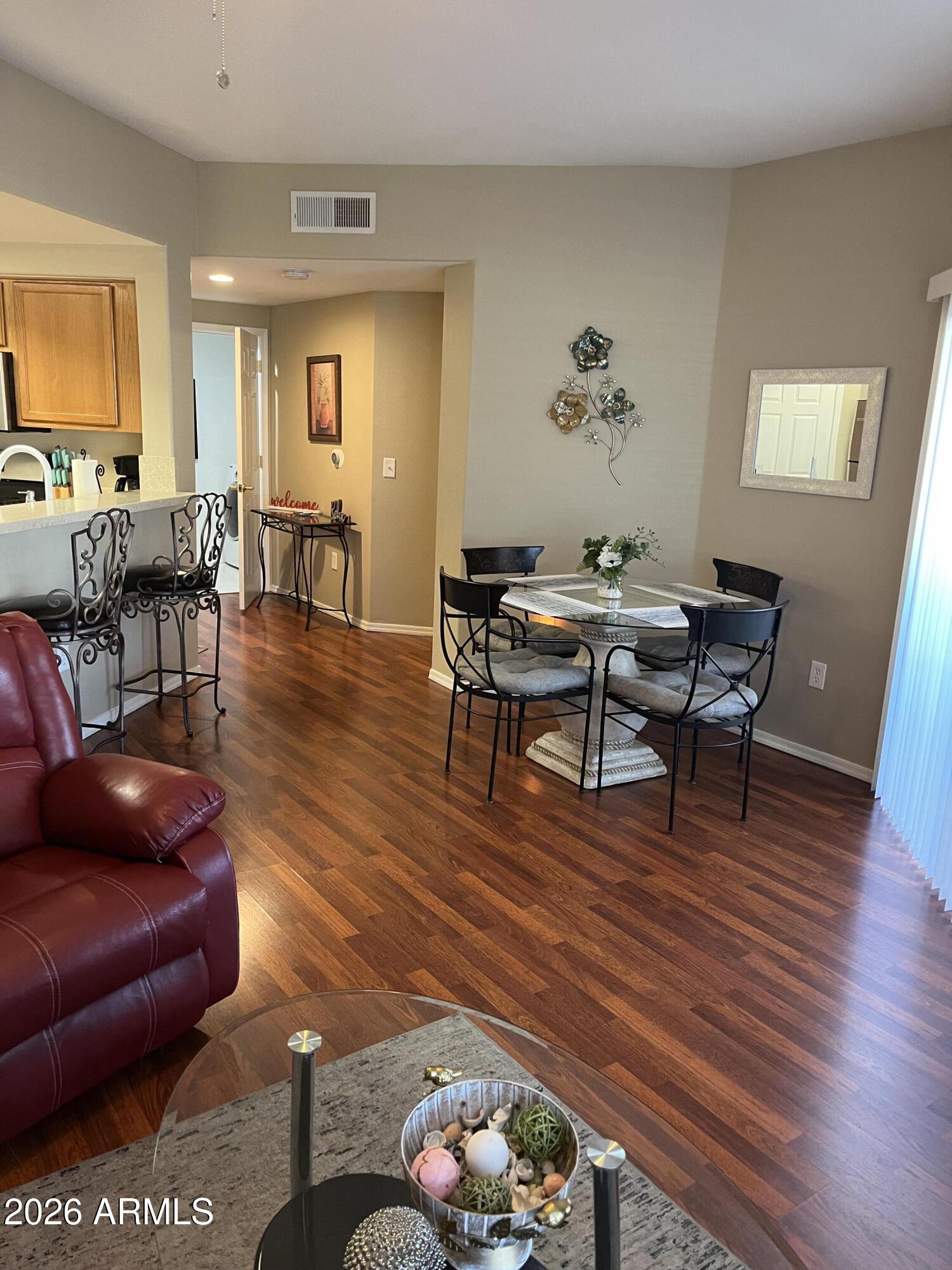 10030 West Indian School Road, Unit 133 Phoenix, AZ 85037 - Photo 7 of 17 a living room with furniture and wooden floor