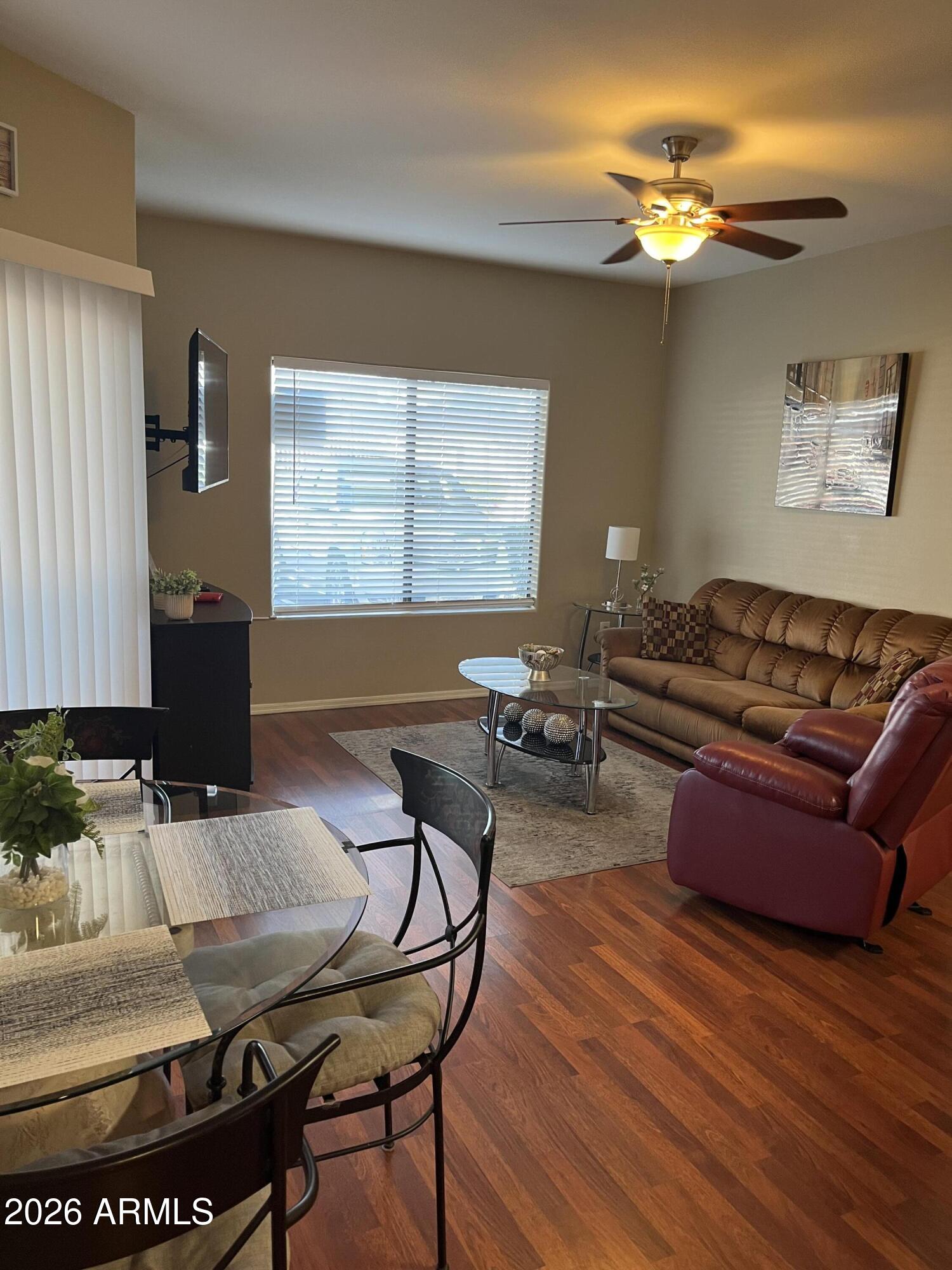 10030 West Indian School Road, Unit 133 Phoenix, AZ 85037 - Photo 9 of 17 a living room with furniture and a large window