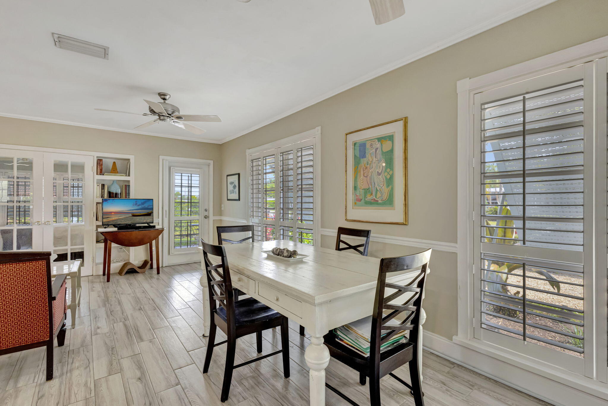 2940 Southeast Treasure Island Road Port St. Lucie, FL 34952 - Photo 11 of 61 a view of a dining room with furniture and wooden floor