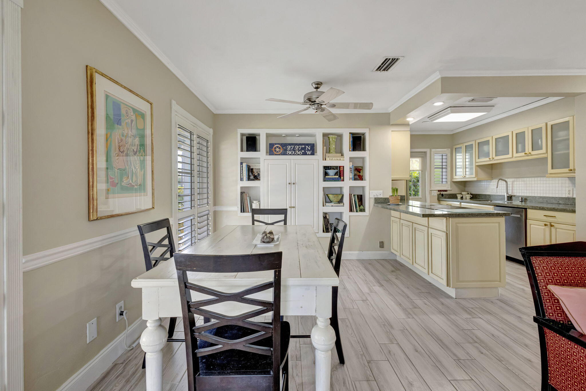 2940 Southeast Treasure Island Road Port St. Lucie, FL 34952 - Photo 12 of 61 a view of a dining room with furniture and wooden floor