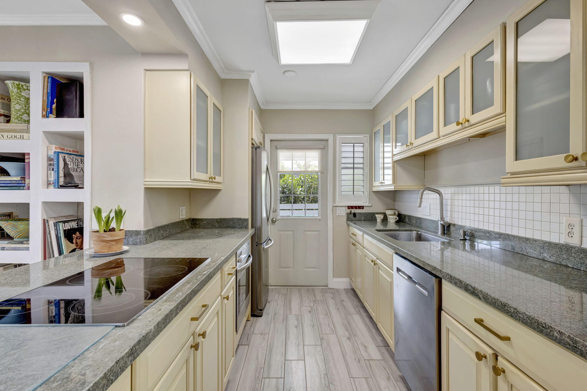 2940 Southeast Treasure Island Road Port St. Lucie, FL 34952 - Photo 15 of 61 a kitchen with stainless steel appliances granite countertop a stove a sink dishwasher and cabinets with wooden floor