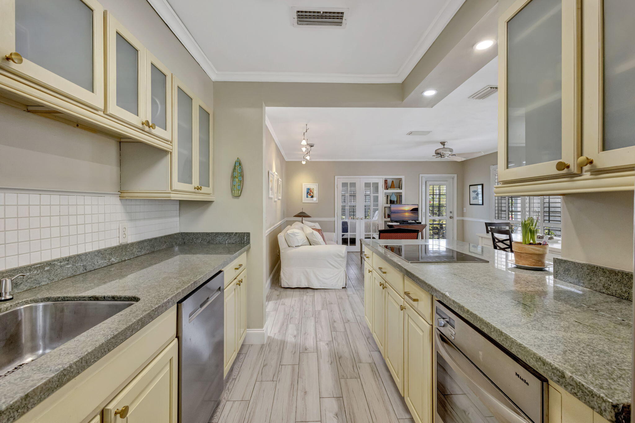 2940 Southeast Treasure Island Road Port St. Lucie, FL 34952 - Photo 17 of 61 a kitchen with granite countertop a sink a counter top space stainless steel appliances and cabinets