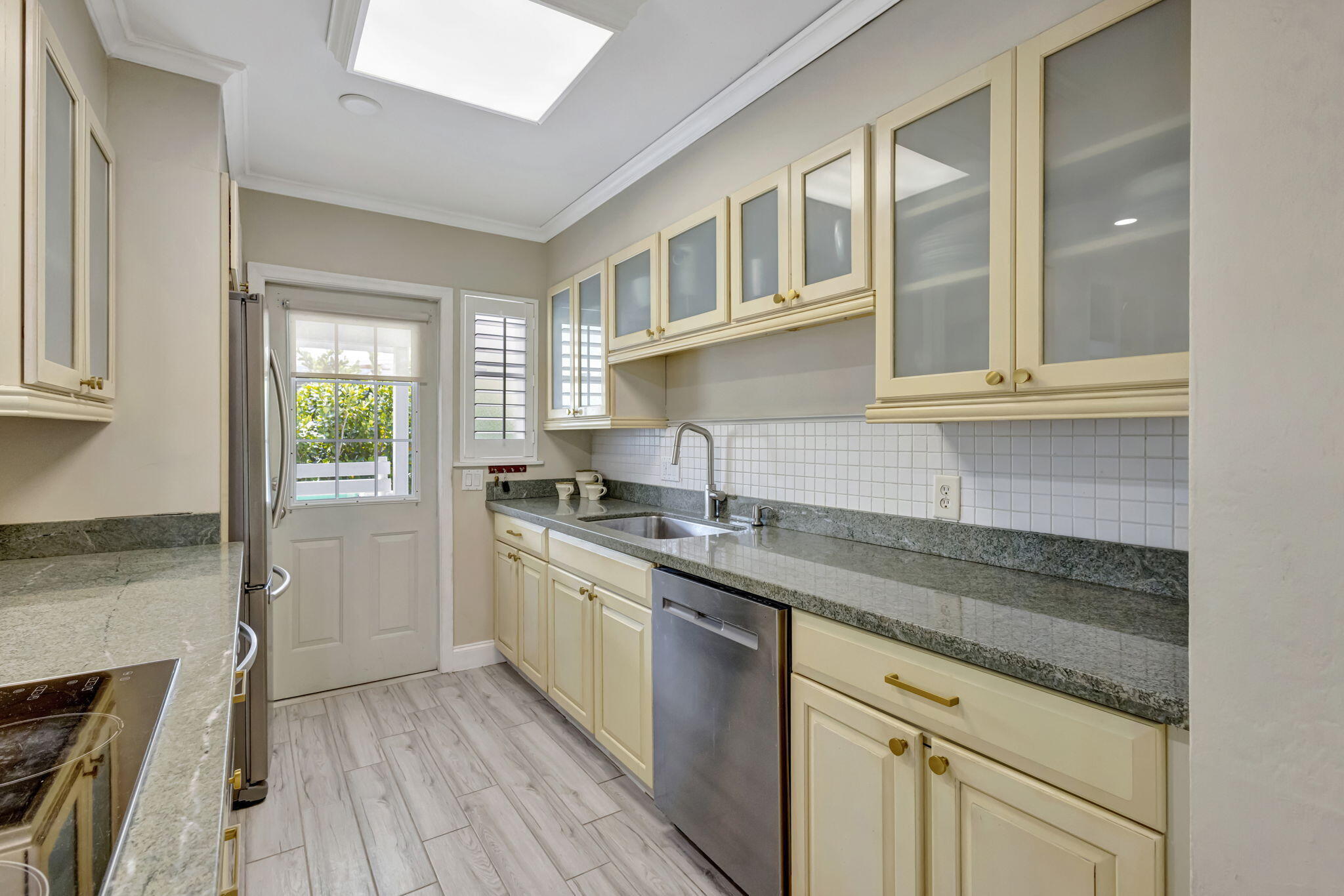 2940 Southeast Treasure Island Road Port St. Lucie, FL 34952 - Photo 18 of 61 a kitchen with a sink stove and cabinets