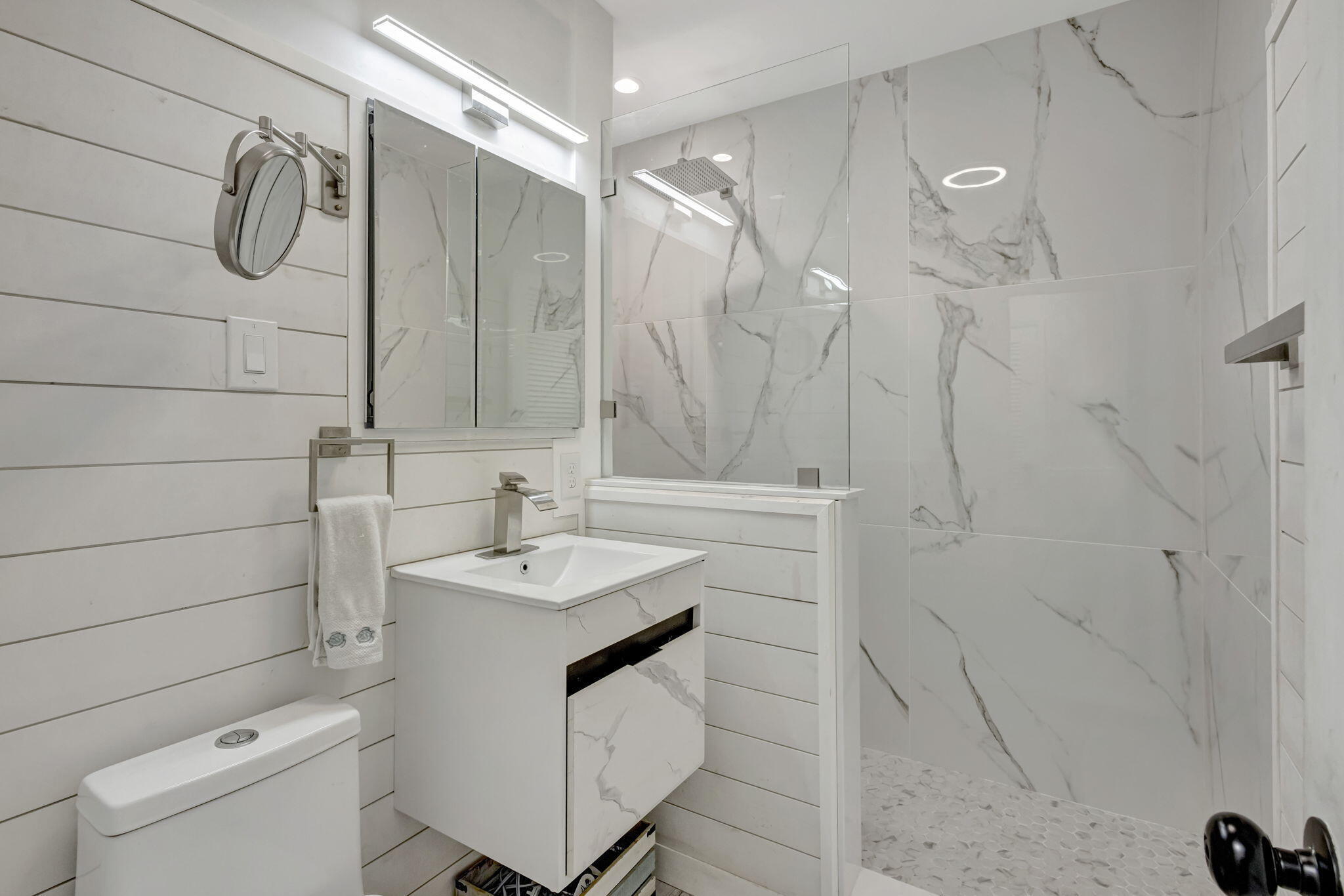 2940 Southeast Treasure Island Road Port St. Lucie, FL 34952 - Photo 22 of 61 a bathroom with a sink a toilet and shower
