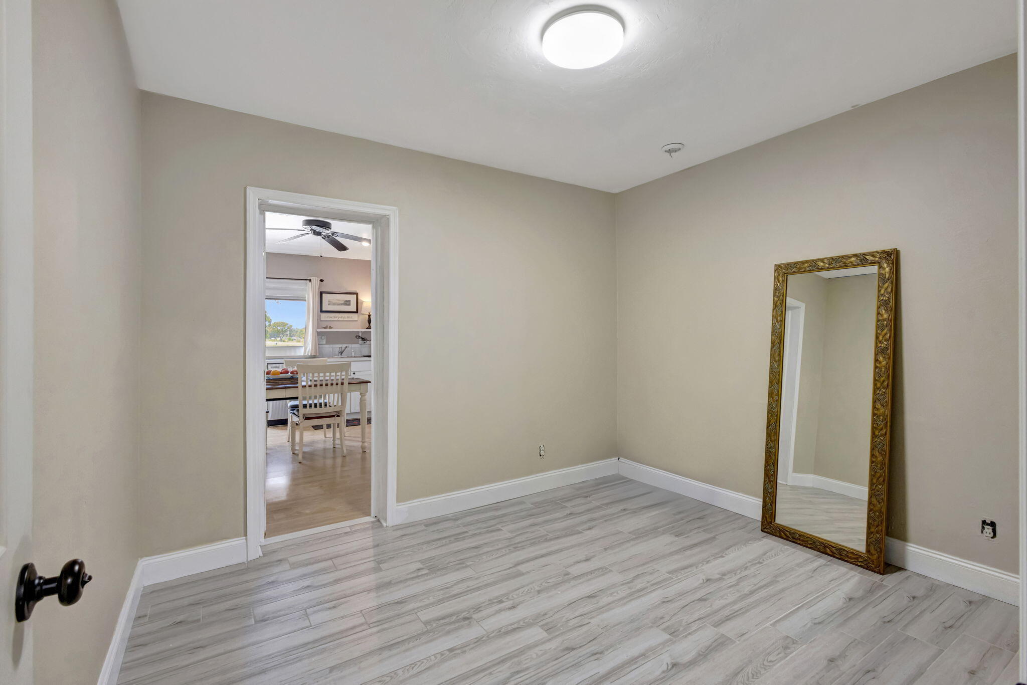 2940 Southeast Treasure Island Road Port St. Lucie, FL 34952 - Photo 24 of 61 a view of empty room with wooden floor