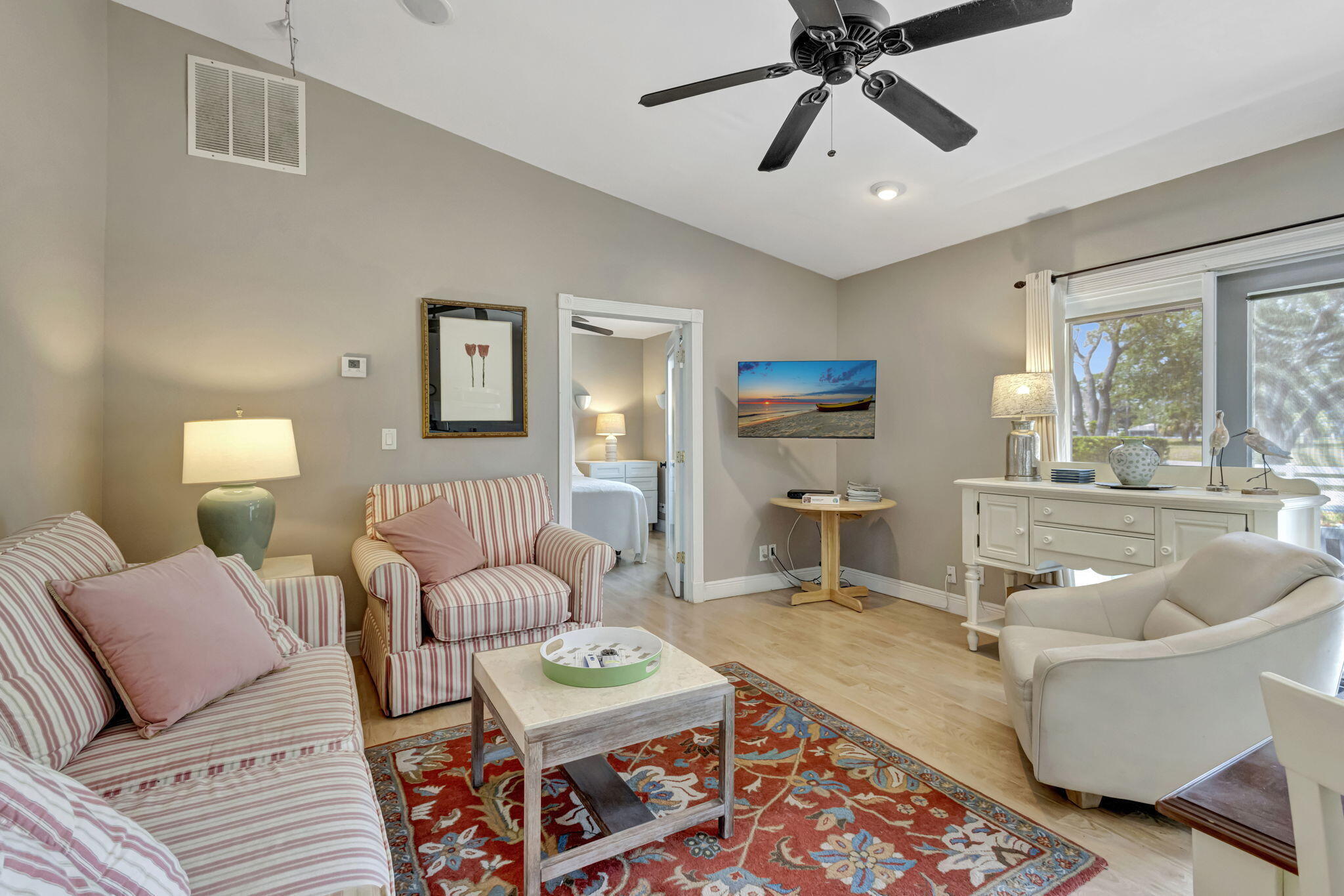 2940 Southeast Treasure Island Road Port St. Lucie, FL 34952 - Photo 25 of 61 a living room with furniture and a chandelier
