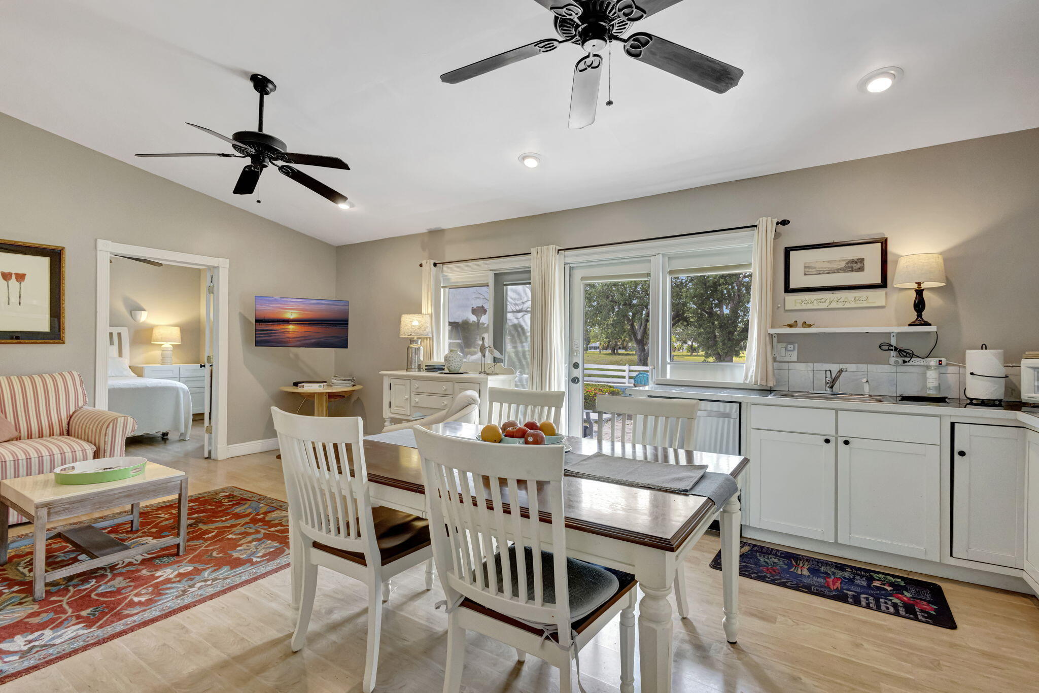 2940 Southeast Treasure Island Road Port St. Lucie, FL 34952 - Photo 27 of 61 a dining room with furniture a window and a chandelier