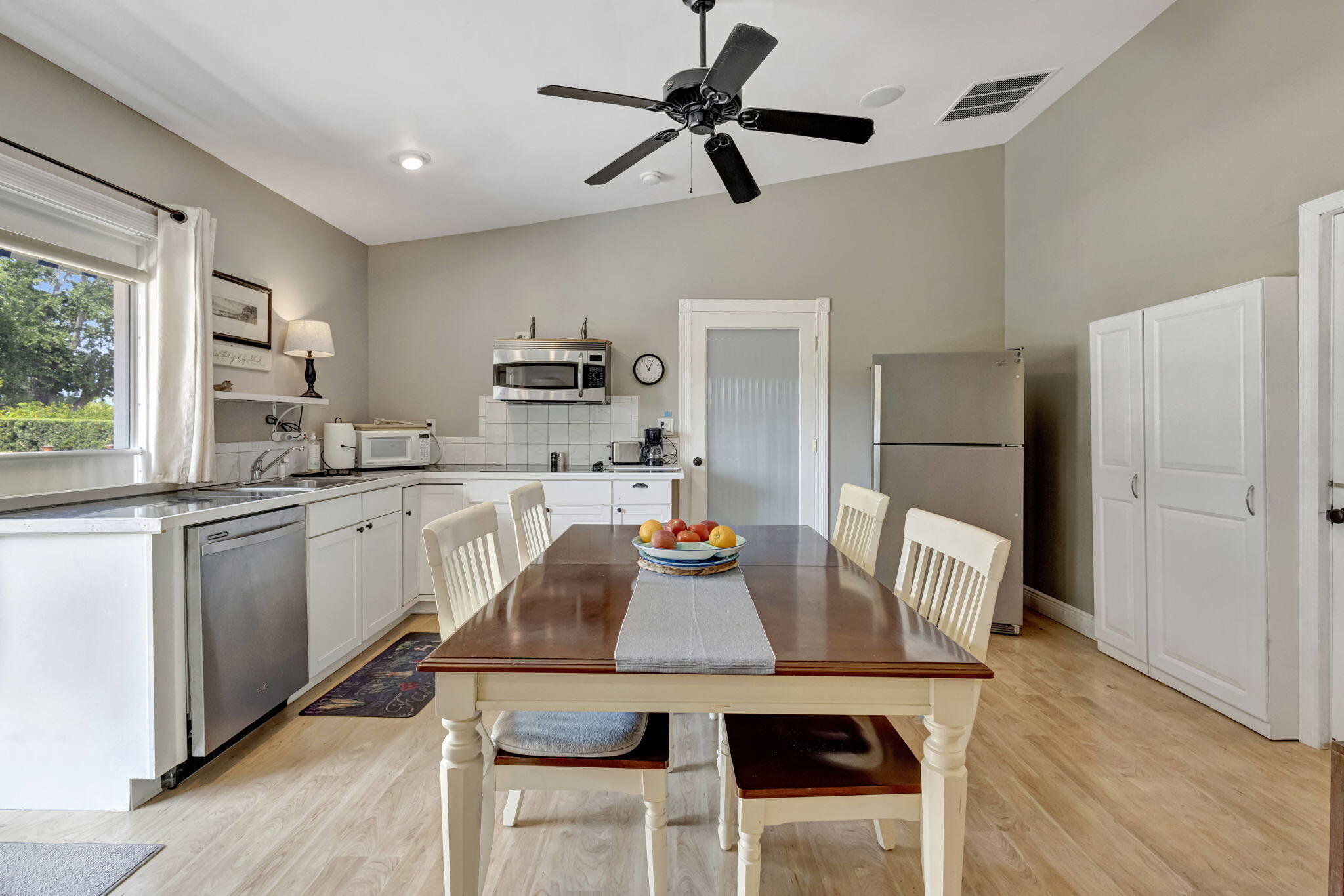 2940 Southeast Treasure Island Road Port St. Lucie, FL 34952 - Photo 30 of 61 a kitchen with a table chairs and refrigerator