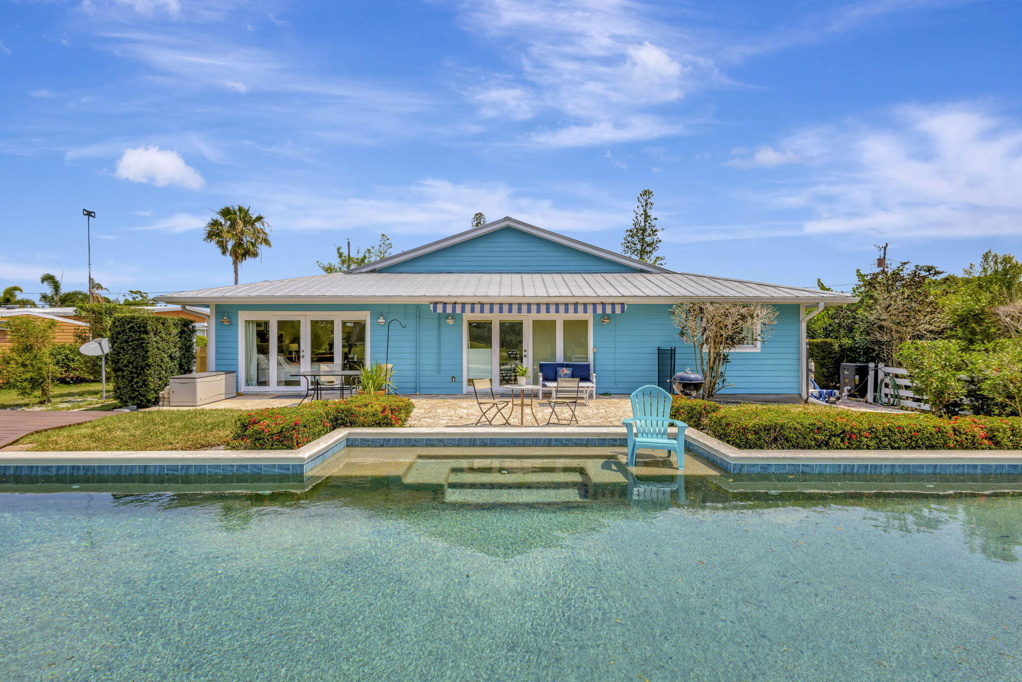 2940 Southeast Treasure Island Road Port St. Lucie, FL 34952 - Photo 3 of 61 a front view of a house with swimming pool