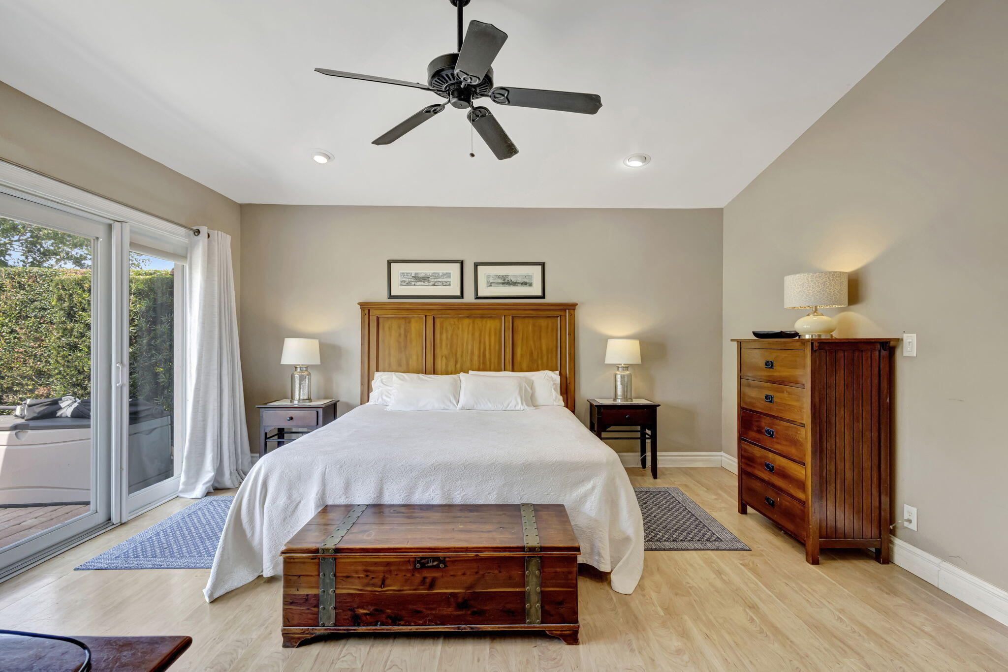 2940 Southeast Treasure Island Road Port St. Lucie, FL 34952 - Photo 32 of 61 a bedroom with a bed a dresser and a chandelier