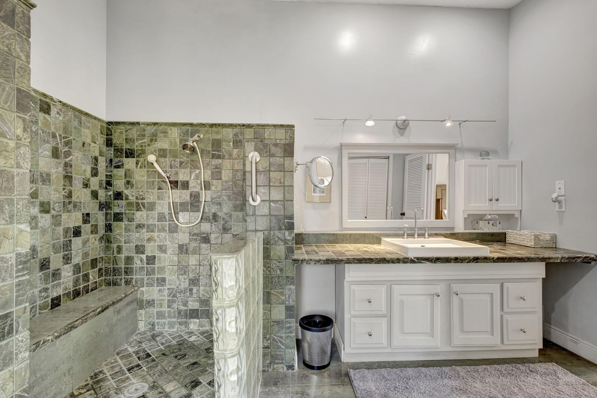 2940 Southeast Treasure Island Road Port St. Lucie, FL 34952 - Photo 35 of 61 a bathroom with a granite countertop sink a mirror and shower