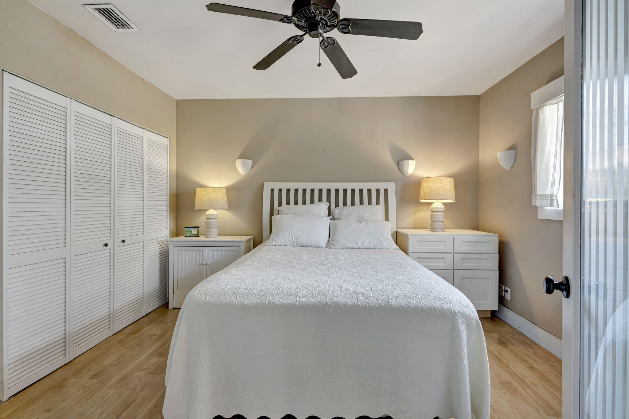 2940 Southeast Treasure Island Road Port St. Lucie, FL 34952 - Photo 38 of 61 a bedroom with a bed and painting on the wall