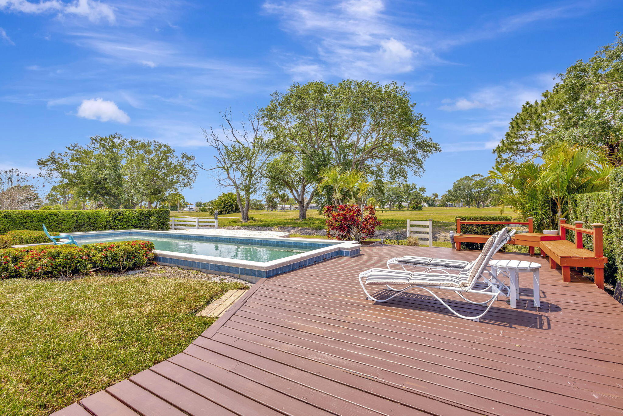 2940 Southeast Treasure Island Road Port St. Lucie, FL 34952 - Photo 46 of 61 a view of a swimming pool with a lounge chair