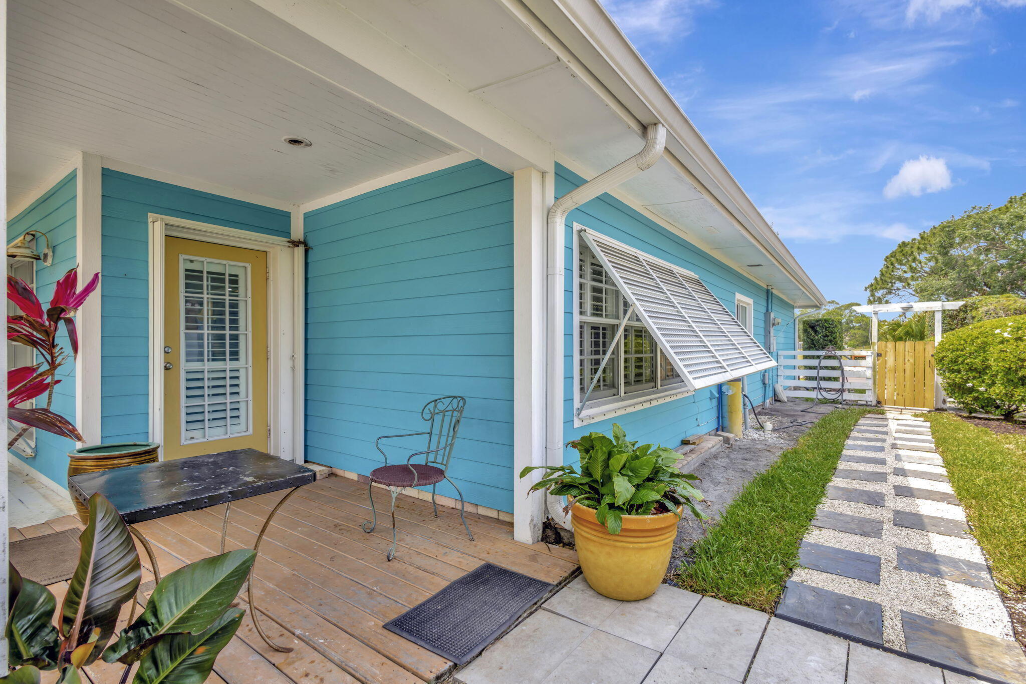 2940 Southeast Treasure Island Road Port St. Lucie, FL 34952 - Photo 5 of 61 a view of a patio with table and chairs and potted plants
