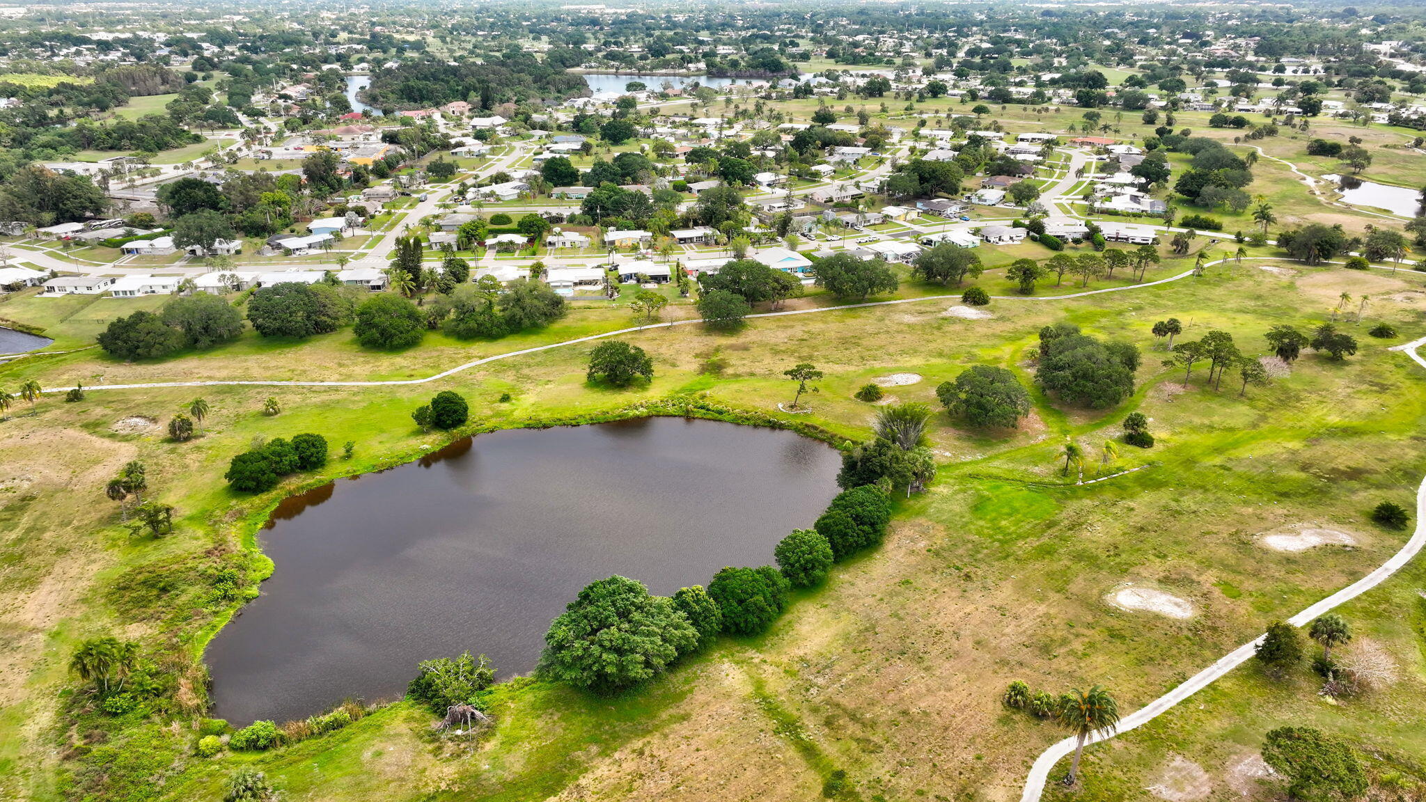 2940 Southeast Treasure Island Road Port St. Lucie, FL 34952 - Photo 55 of 61 an aerial view of residential houses with outdoor space