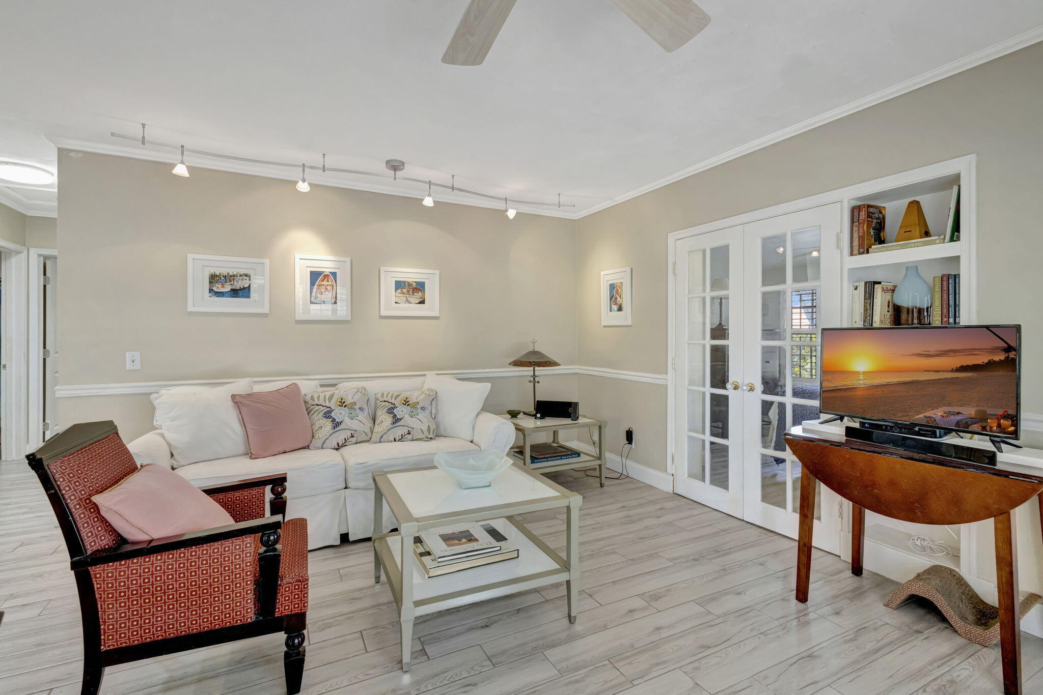 2940 Southeast Treasure Island Road Port St. Lucie, FL 34952 - Photo 8 of 61 a living room with furniture a rug and a flat screen tv