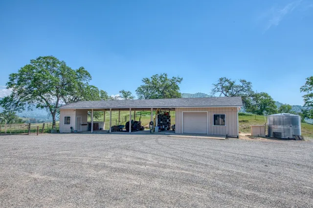 a dining hall with stainless steel appliances granite countertop a sink table and chairs