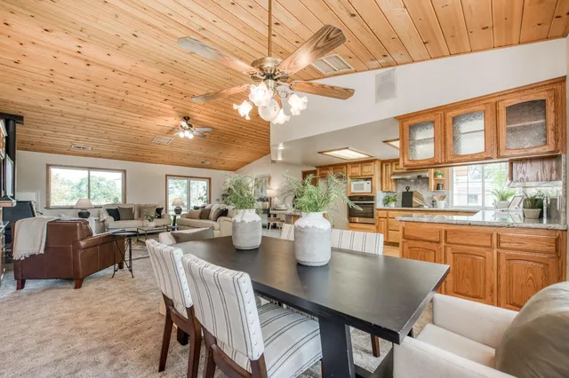 a living room with furniture a fireplace and a table