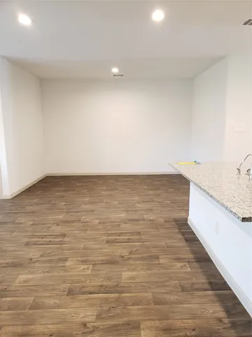 a view of room with wooden floor