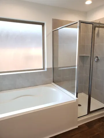 a bathroom with a bathtub and a shower