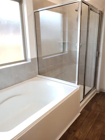 a bathroom with bathtub and shower