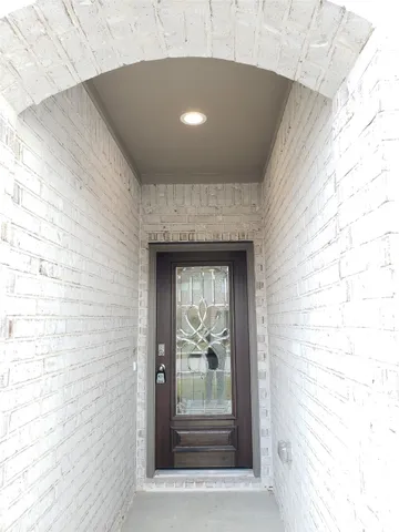 a view of a hallway with wooden floor and a fireplace