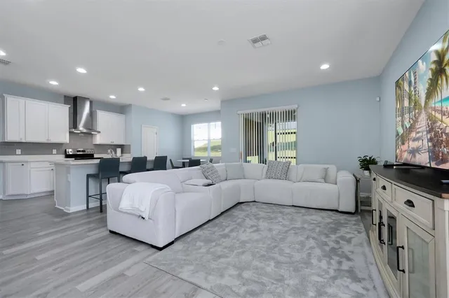 a living room with furniture and a large window