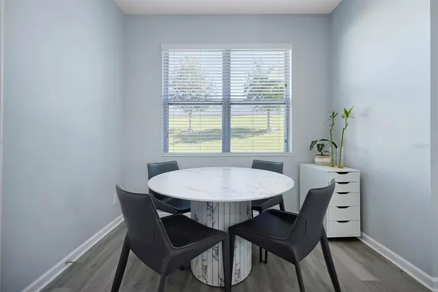 a view of a dining room with a table and chairs
