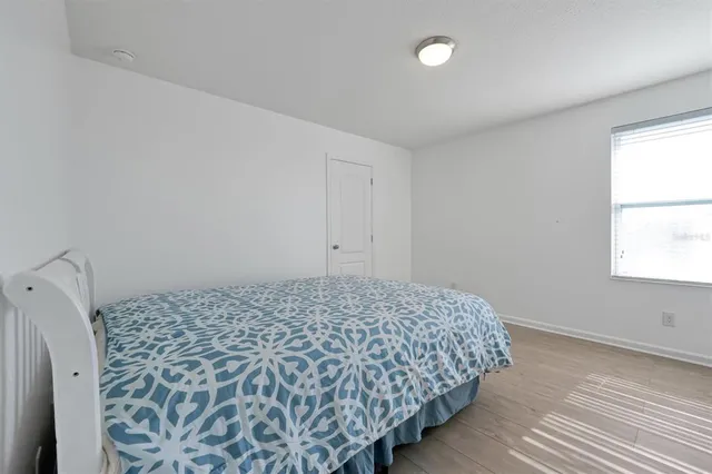 a bedroom with a bed and a ceiling fan