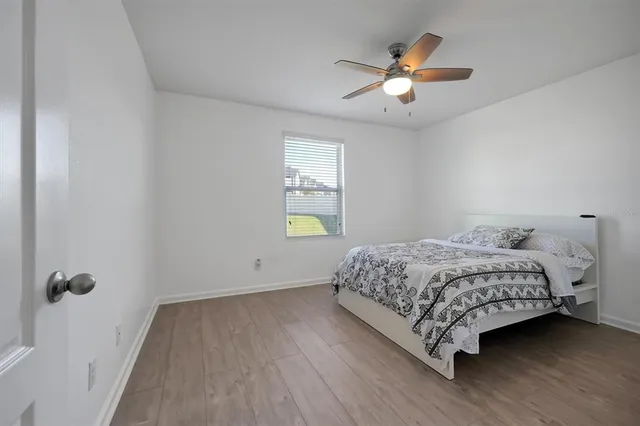 a bedroom with a bed and window