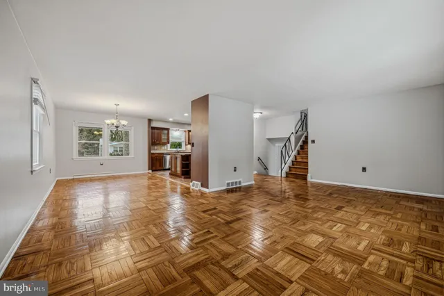 a view of empty room with a kitchen