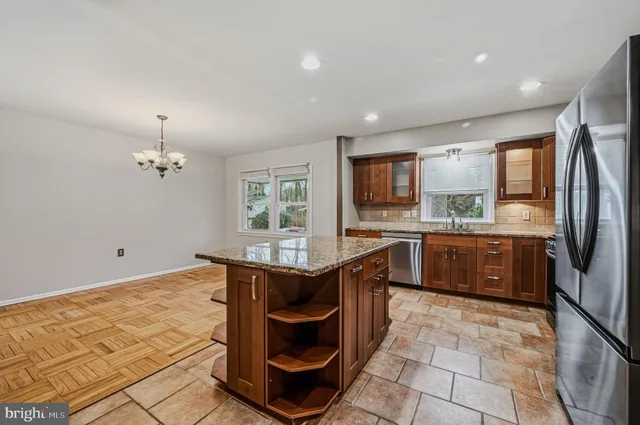 a kitchen with stainless steel appliances granite countertop a sink counter space cabinets and a counter top space