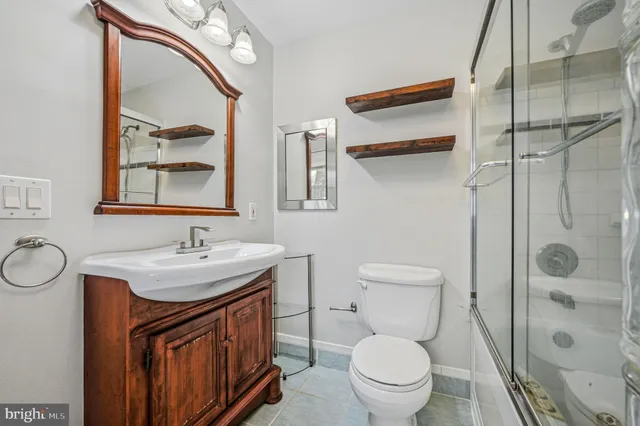 a bathroom with a toilet a sink and mirror
