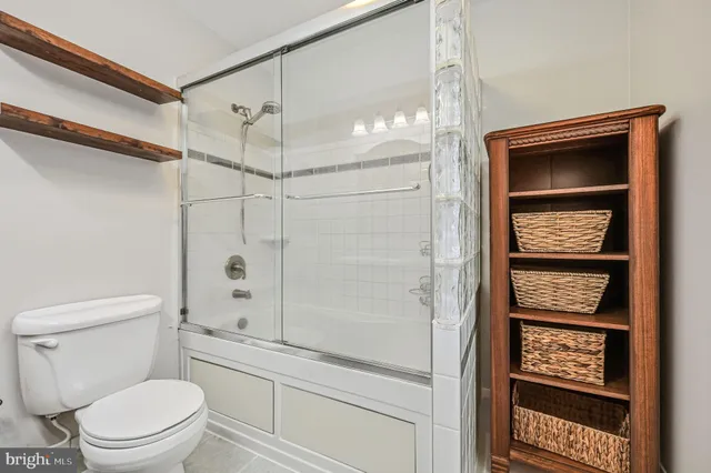 a bathroom with a toilet a sink and shower