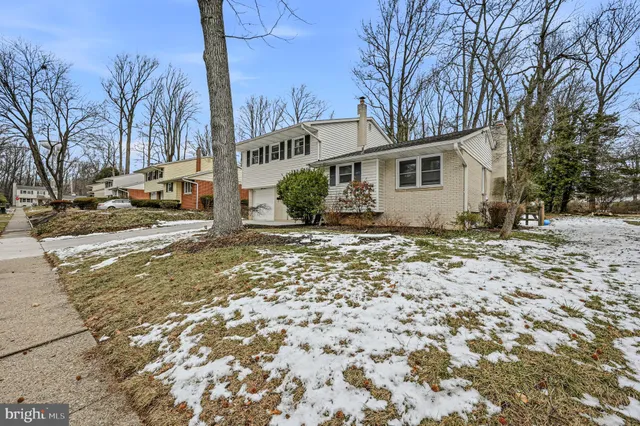 a view of a house with a yard covered in snow