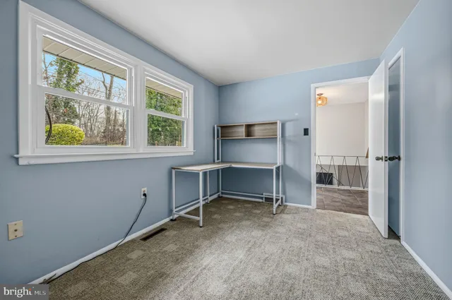 a view of workspace with furniture and window
