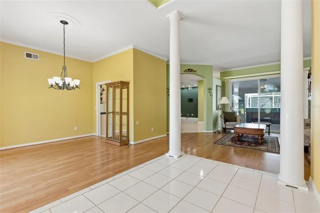 a view of a chandelier fan and wooden floor