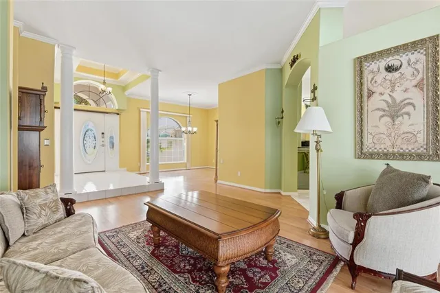 a view of a hallway with wooden floor and a dining room