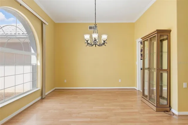 a large white kitchen with a refrigerator and a stove top oven