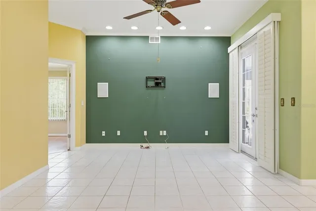a view of a livingroom with a chandelier furniture and a ceiling fan