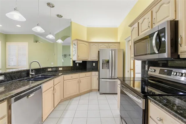a kitchen with granite countertop stainless steel appliances and a counter top space