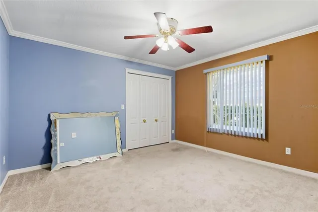 a view of a house with a big yard and large trees
