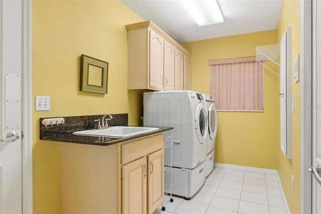 a front view of a house with garden and trees