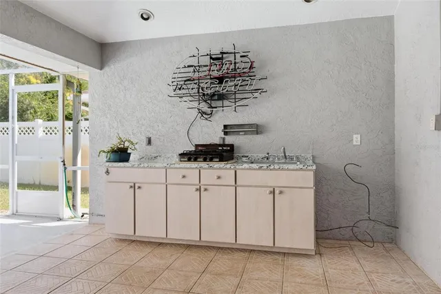 a view of a white house with a yard potted plants